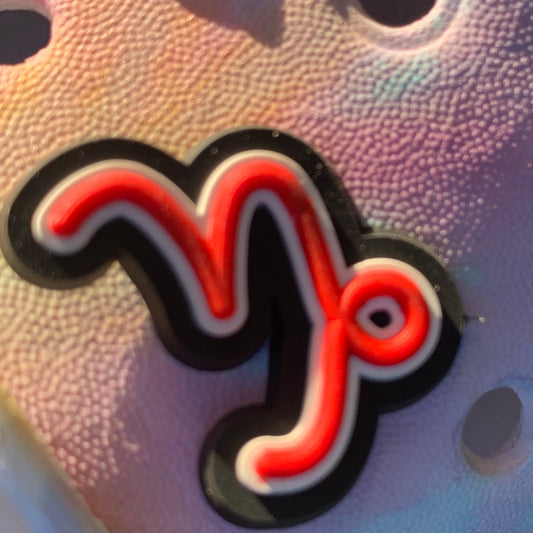 a pair of orange scissors on a table 