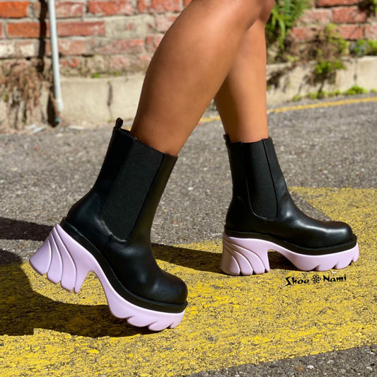 Weeboo CITY-10 Lilac

- Black Faux Leather
-&nbsp;Pull-On Chelsea Ankle Bootie
- Elastic Insets
- Chunky&nbsp;Lilac&nbsp;Purple Grooved&nbsp;Lug Sole &amp; Heel, Approx. 2"
- Also Available in Hot Pink, Orange, Red