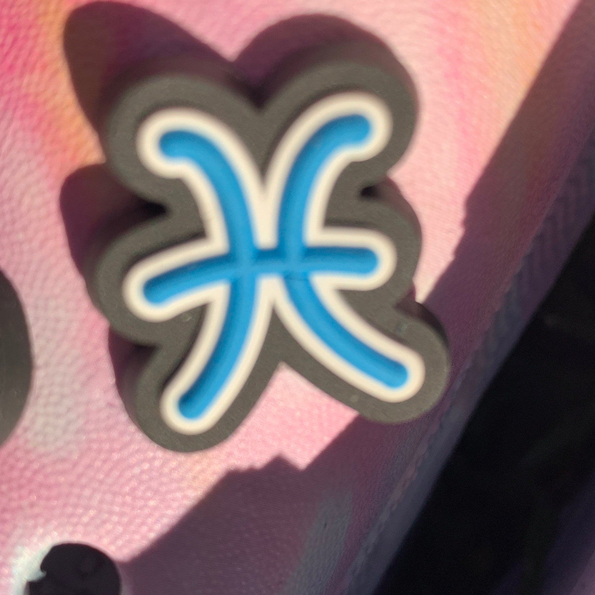 a close up of a pair of scissors on a pink box 